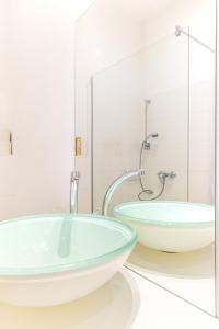 a bathroom with two sinks and a shower at Luxurious and Bright, 5 min to city center in Vienna