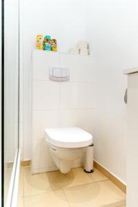 a white bathroom with a toilet and a shower at Luxurious and Bright, 5 min to city center in Vienna