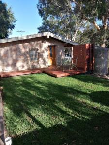 a small house with a lawn in front of it at Maunder Cottage in Aldinga