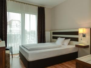 Postel nebo postele na pokoji v ubytování Hotel Nordhausen