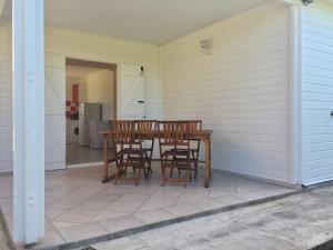 a patio with a table and chairs on a house at Villa Anse Clemence in Anse-Bertrand