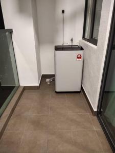 a small refrigerator in a room with a tile floor at Sutera Homestay Vista Bangi with WIFI in Bangi