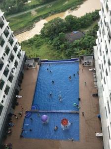 an overhead view of a swimming pool with people in it at Sutera Homestay Vista Bangi with WIFI in Bangi