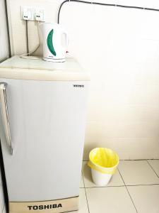 a small refrigerator in a kitchen with a trash can at TuR11-Oppesite Pisa Stadium-1min-FoodCourt-MiniMarket in Bayan Lepas