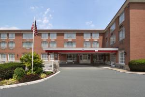 a building with an american flag in front of it at Ramada by Wyndham Ligonier in Ligonier