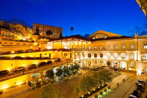 a building with cars parked outside of it at night at Hotel INN Rossio in Lisbon