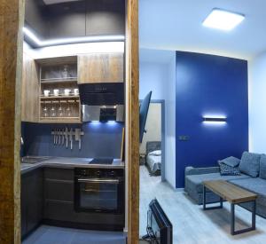 a kitchen and living room with a couch and a table at Pasta Amber Lux in Liepāja