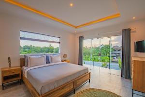 Un dormitorio con una cama y una ventana grande. en Hedonia Luxury Villas, en Seminyak 236 fotos más