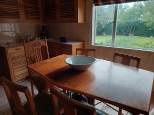 a kitchen with a wooden table with a bowl on it at Three Sons Guest Farm in Loxton