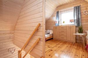 a room with a staircase in a wooden house at Domki U Wojtka w Niechorzu in Niechorze