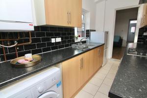 a kitchen with a sink and a dishwasher at Tranquil 3Bed Retreat - Walk to Coventry University, Fargo Village & Coventry City Centre in Coventry