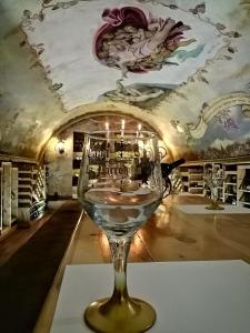 a wine glass sitting on a table in a wine cellar at Hotel & Cava La Parroquia in San Cristóbal de Las Casas