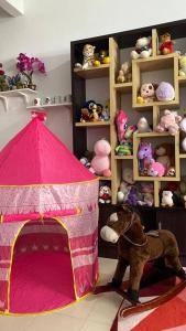 a pink play tent with a bunch of stuffed animals at HOMESTAY DELISHA PARIT RAJA UTHM in Parit Raja
