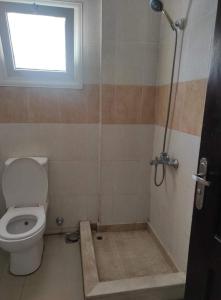 a bathroom with a toilet and a window at Sunny dahab in Dahab