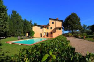 a villa with a swimming pool in front of a house at Villa Selva in Lastra a Signa