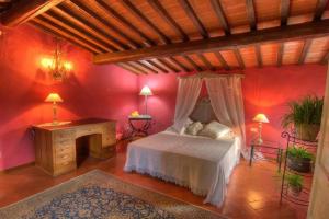 a bedroom with red walls and a bed and a fireplace at Villa Selva in Lastra a Signa +20 photos