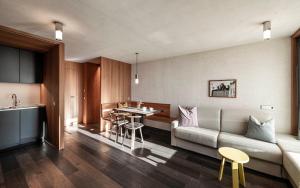 a living room with a couch and a table at La Paula Apartments & Suites in Siusi