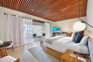 Postel nebo postele na pokoji v ubytování Tago Tulum by G Hotels