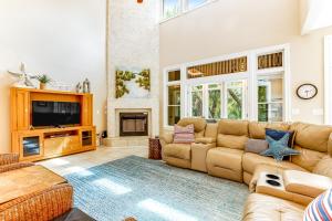 a large living room with a couch and a tv at Bufflehead 3 in Kiawah Island