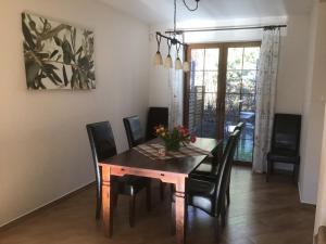 a dining room with a wooden table and chairs at Dom za Wydmą in Rogowo