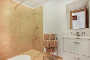 a bathroom with a shower and a toilet and a sink at Duquesa Harbour Club Aparthotel in Manilva
