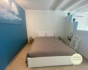 una camera con un letto in una stanza blu e bianca di Dimora Pugliese a Palo del Colle