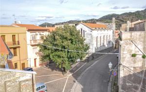 a city street with a tree and buildings at 2 Bedroom Awesome Apartment In Cuglieri in Cuglieri