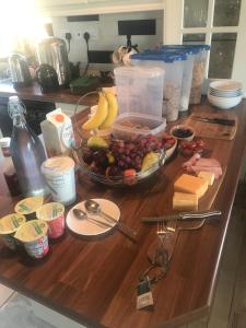 a table with a bowl of fruit and cheese at Cappa House B&B in Eyeries