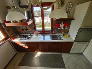 a kitchen with a sink and a stove and a window at Grazioso rustico Toscano in Luciana