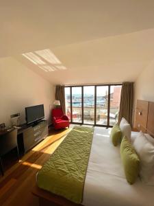 a bedroom with a large bed with a large window at Cassis Loc - Chambre Meublée in Cassis