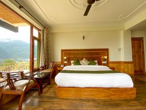 a bedroom with a large bed and a balcony at Nature Bliss - Mount Serene in Manāli