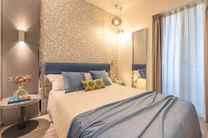 Postel nebo postele na pokoji v ubytování Romagna Suite Hotel