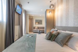 um quarto com uma cama grande e almofadas em Romagna Suite Hotel em Gatteo a Mare