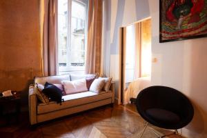 sala de estar con sofá y ventana en High Stay Saint Germain de Pres Paris 6, en París