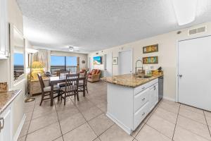 a kitchen and dining room with a view of the ocean at Harbour Place 313 in Gulf Shores