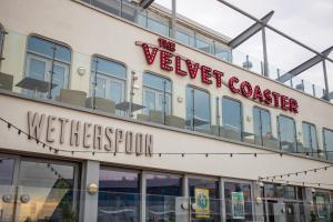 a building with a welcome sign on the side of it at Withnell Stays - Apartment Three in Blackpool