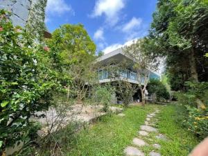 a house with a garden in front of it at The SkyView Villa & Resort in Kệ Sơn