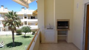 a balcony with a kitchen with a view of a building at Vila Atlantida Apartment in Vilamoura