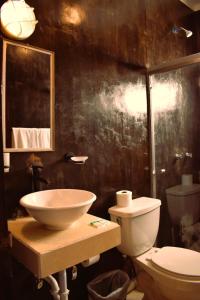 a bathroom with a sink and a toilet at Ventana Blue Hotel in El Sargento