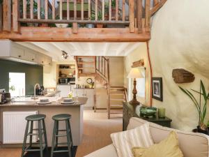 a kitchen and living room with a loft at The Byre in Bideford