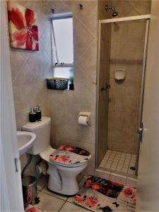 a bathroom with a toilet and a shower at @Menlyn Place, Menlyn Maine, Pretoria - Accommodation in Pretoria