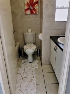 a bathroom with a toilet and a sink at @Menlyn Place, Menlyn Maine, Pretoria - Accommodation in Pretoria