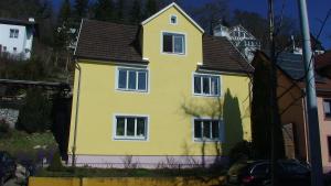 a yellow house with a black roof at Haus Wunderlich in Sigmaringen
