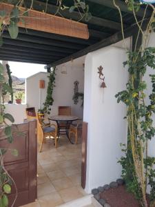 a patio with a table and chairs in a house at Villa Harmony in Charco del Palo
