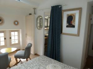 a bedroom with a bed and a chair and a table at chambre campagnarde in Bargème