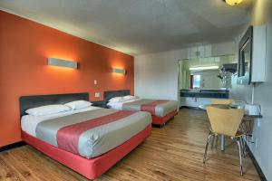 a hotel room with two beds and a kitchen at Motel 6-Lima, OH in Lima