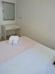 a bedroom with a bed with two towels on it at Apartman Nina in Gradac