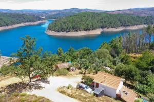 an aerial view of a house and a lake at Star Gazing Luxury Yurt above beautiful RIVER, off grid in Vale do Barco