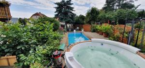 a backyard with a swimming pool and a hot tub at Ferienwohnung Moritzburg mit Pool in Moritzburg