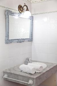 a bathroom with a sink and a mirror and towels at Villas Bocaina Beach in Puerto del Carmen